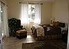 This bedroom has a comfortable Queen bed, relaxing arm chair and amazing views of Kapoho Bay.