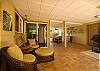The lounge area of the covered lanai has two seating areas for comfort.