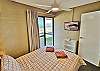 Main Queen Bedroom with TV and access to own small balcony with uninteruted views of river and marina.. 