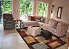 Main level living area with glass front looking out into the rushing waters of the river