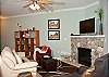 Relax In Comfortable Elegance With an LCD TV and River Rock Fireplace