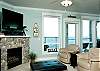 Relax In Comfortable Elegance With an HDTV and River Rock Fireplace