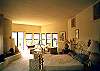 Master bedroom with adjacent sitting area and fireplace