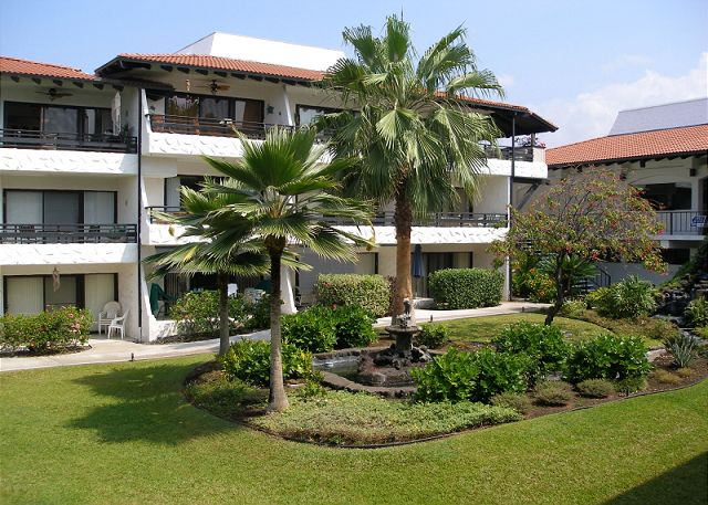 Tropical courtyard with a dolphin water fountain.