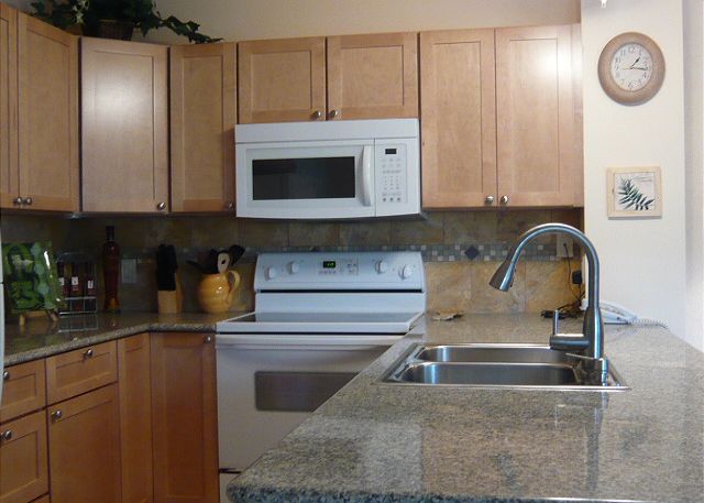 New granite, cabinets, & tile in the kitchen