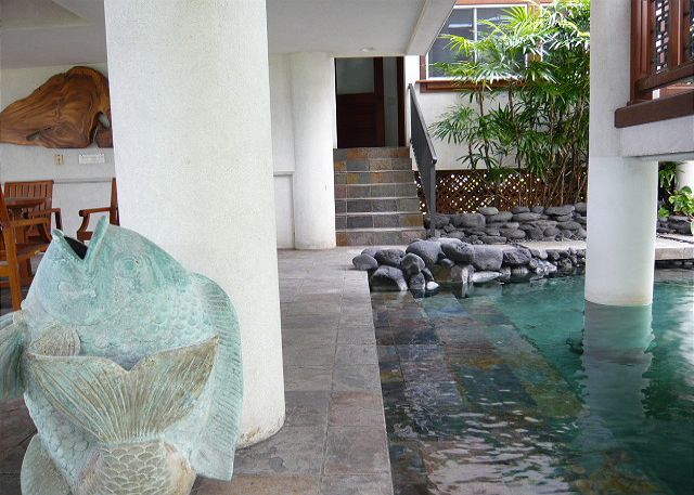 Lower level lanai with pool access and entry to the front door o