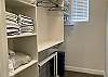 The walk-in closet in the main room is equipped with extra towels and linens, a baby gate, and a pack n play. 