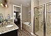 The Main bathroom that is adjacent to the Main bedroom is large and luxurious. With his and her sinks, toilet, vanity, walk-in shower, large bathtub and a large walk-in closet.