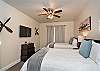 Bedroom 3 is furnished with 2 Full size beds and inculdes a private TV, night stand, lamp, and ceiling fan.