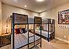 Bedroom 5 is located on the lower level and is a large and spacious room with Full over Full bunk bed and Twin over Twin bunk bed. 