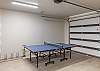 Located in the garage, this ping pong table provides fun for all your guests. 