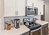 This beautiful Kitchen has all the upgrades and shows a keurig coffee maker and tea kettle. 