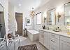 The main bathroom that is adjacent to the main bedroom is large and luxurious. With his and her sinks, toilet, vanity, walk-in shower, large bathtub and a large walk-in closet.