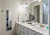 The thoughtfully crafted main bathroom has a double vanity, full size mirror, and walk-in shower for your convenience.