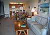 Living room, dining area and kitchen, all with lake view