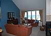 Living room with flat screen TV and lake view