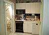 Kitchenette with stove top, dishwasher, microwave and mini fridge