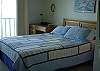 Master bedroom with queen bed, fireplace and lake view