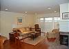Living room with hardwood floors, fireplace and lake view
