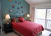 Master bedroom with queen bed and a lake view