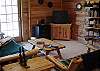 Family room with futon and walk-out deck on the lower level