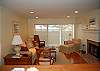 Living room with hardwood floors, fireplace and lake view