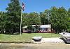 Large lawn with small beach area, canoe and rowboat available, and 100 feet of lake frontage