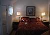 Master bedroom with queen bed and private bath in the upper level loft