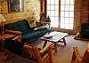 Family room with futon and walk-out deck on the lower level