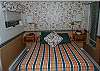 Master bedroom with queen bed and private bath in the upper level loft