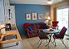 Living space with sofa bed, dining table and kitchenette
