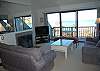 Living room with fireplace, flat screen TV and river and lake views