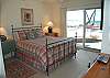 Master bedroom with queen bed, private bath and lakeside deck
