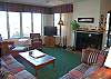 Living room with fireplace, flat screen TV and lake view