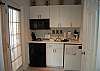 Kitchenette with stove top, microwave, dishwasher and mini fridge