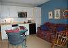 Living space with sofa bed, dining table and kitchenette