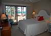 Master bedroom with queen bed and lake view