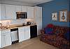 Kitchenette with a glass stove top, microwave, mini fridge and dishwasher