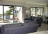 Living room and dining room, both with a deck overlooking the Crystal River and Lake Michigan