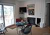 Living room with dining table, fireplace and flat screen TV