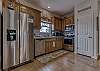 The large, spacious kitchen offers stainless appliances which include a dishwasher, built in microwave, stove with smooth cooktop and a side by side refrigerator. 