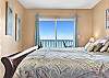 The Gulf Front Bedroom has a King Bed, Chest of Drawers, & Television. There are also spectacular views of the Gulf of Mexico, and access to the private balcony.