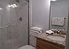 The private bathroom features a beautiful, tile shower, and is fully stocked with linens for your stay.