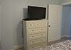 Guest bedroom 1 offers a chest of drawers for storing your personal belongings out of sight, and also a television.