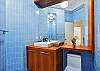 This is the en suite bathroom to the Brick Room with walk-in shower and cheery blue tile throughout.