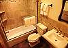 Upgraded shared bathroom, stone tile throughout, tub/shower combo.