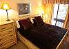 King bed, custom bedding, excellent lighting.