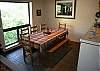 Seating for eight, tile flooring, spacious dining area.
