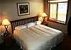 King size bed, upgraded bedding and pillows, and TV