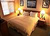Master bedroom features King bed with comfortable bedding and upgraded furnishings.